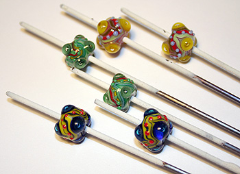 Finished glass beads on mandrels